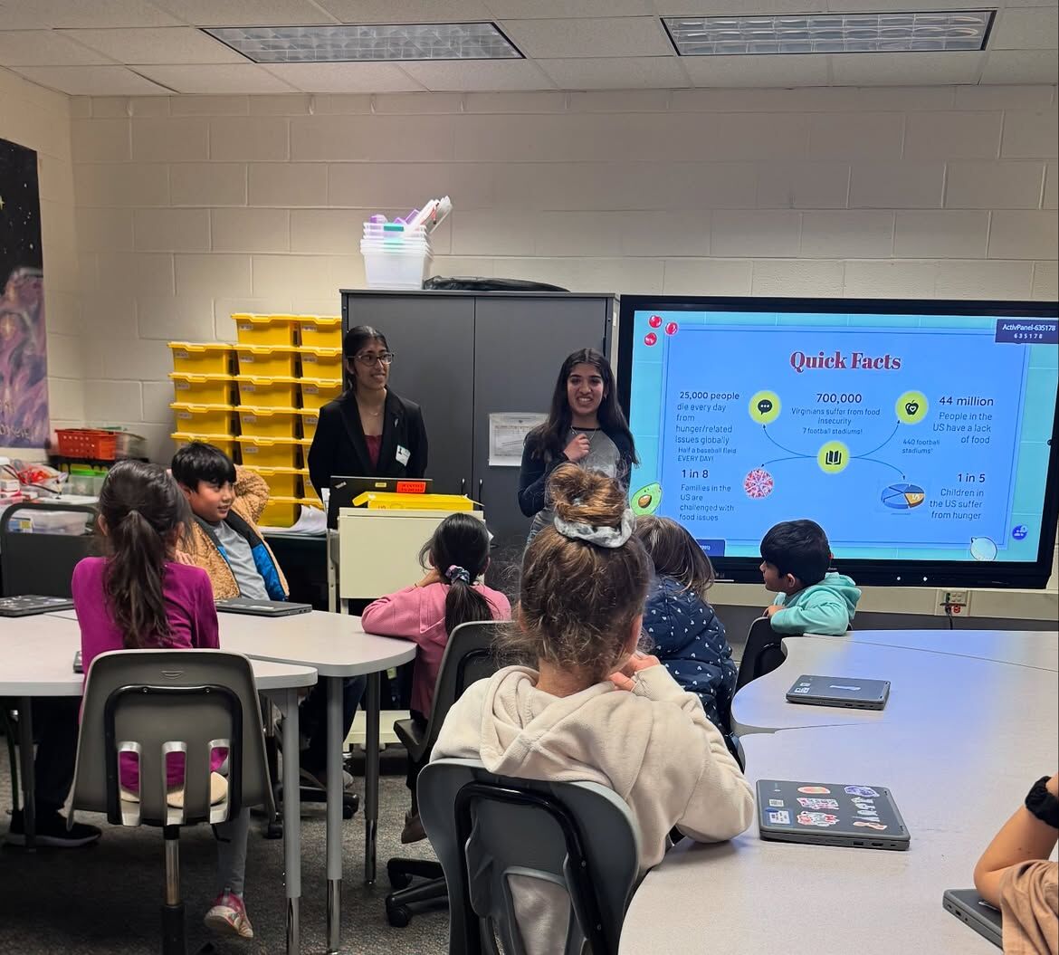 Two Second Harvest leaders presenting to elementary students